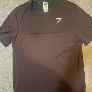 Men’s gym shark workout t-shirt .The color is more a Maroon color not brown